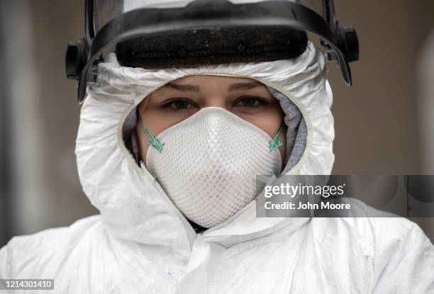 Nurse Hannah Sutherland, dressed in personal protective equipment awaits new patients at a drive-thru coronavirus testing station at Cummings Park on...