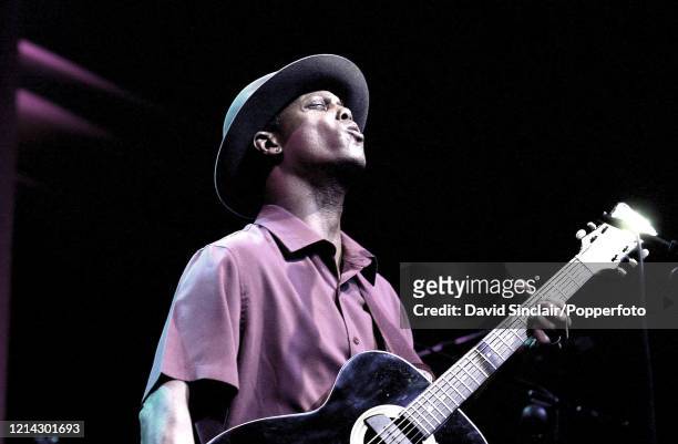 American singer and guitarist Eric Bibb performs live on stage at Cabot Hall in London on 10th April 2002.