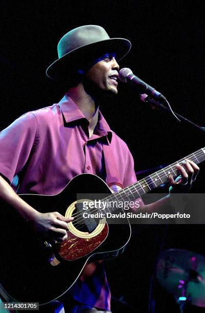 American singer and guitarist Eric Bibb performs live on stage at Cabot Hall in London on 10th April 2002.