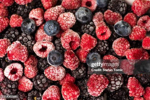 bunch of frozen berry fruit background pattern - frozen berries stock pictures, royalty-free photos & images