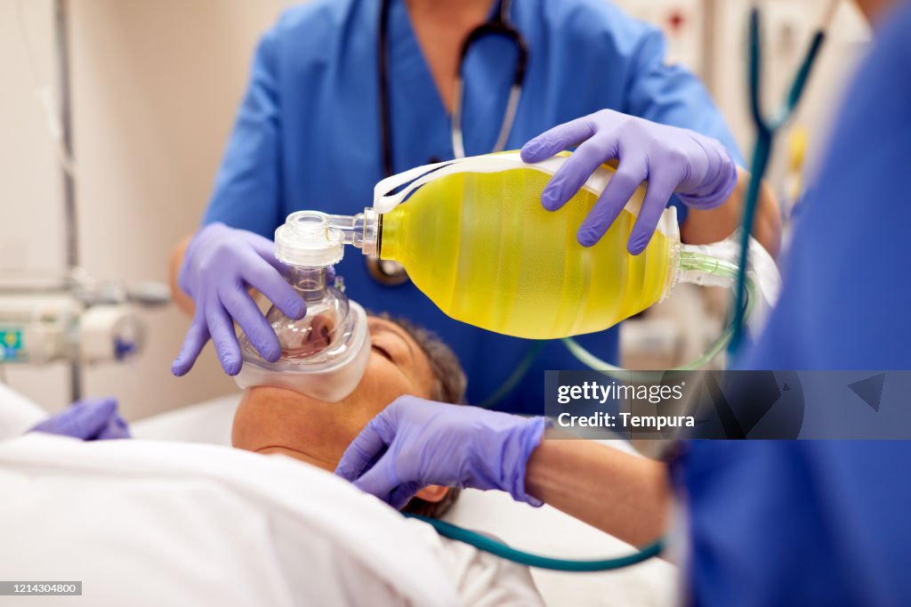Close up view of manual medical ventilator on a patient.
