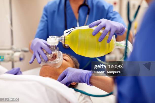 close up view of  manual medical ventilator on a patient. - ventilator stock pictures, royalty-free photos & images