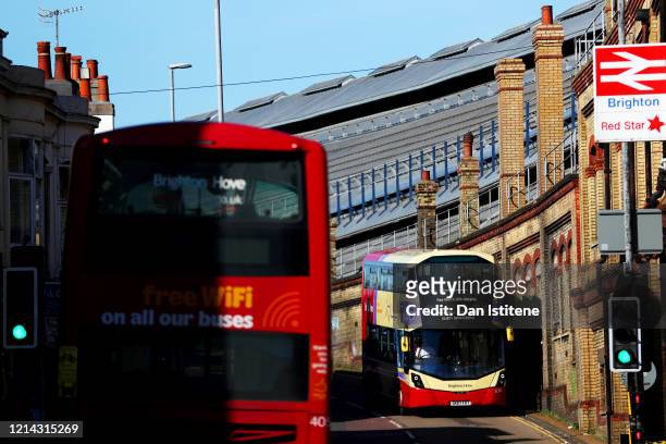 Buses pass Brighton train station on March 23, 2020 in Brighton, United Kingdom. As part of social distancing Public Health England has advised...