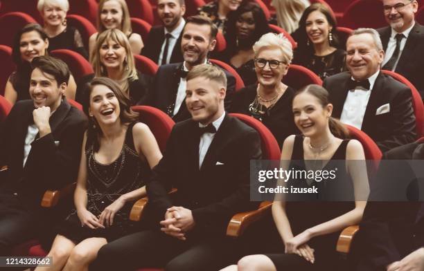 happy audience sitting in opera house - british film reception inside stock pictures, royalty-free photos & images