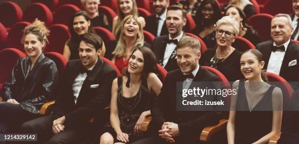 happy audience sitting in opera house - british film reception inside stock pictures, royalty-free photos & images