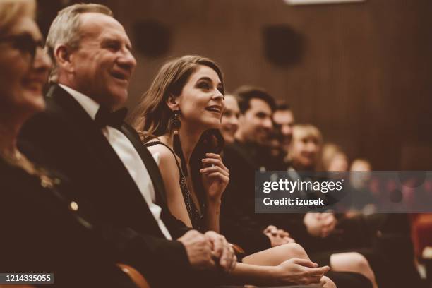 smiling audience sitting in the theater - arts for humanity gala imagens e fotografias de stock