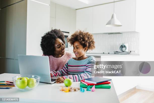 mother learning with child - homework laptop stock pictures, royalty-free photos & images