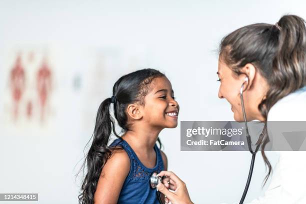 young girl is examined by female doctor stock photo - spanish and portuguese ethnicity stock pictures, royalty-free photos & images