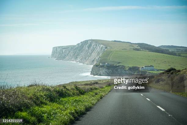 driving along freshwater bay, isle of wight, england - isle of wight stock pictures, royalty-free photos & images