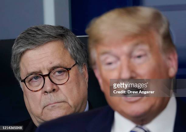 Attorney General William Barr , listens to U.S. President Donald Trump speak at the daily coronavirus briefing at the White House on March 23, 2020...