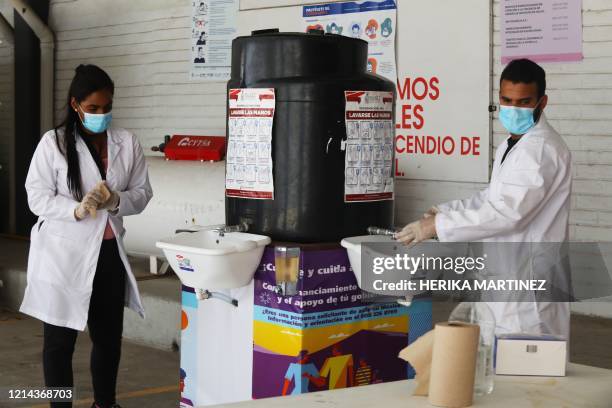 Migrant doctors from Venezuela and Cuba wash their hands at the so-called "filter hotel', which is rented by the World Organization for Peace and the...