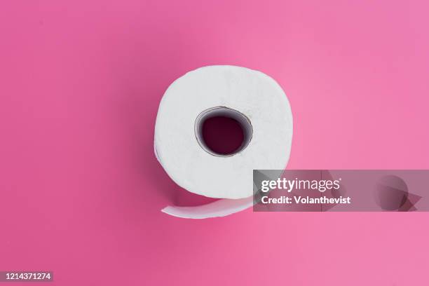 white toilet paper on pink background - man toilet stock-fotos und bilder