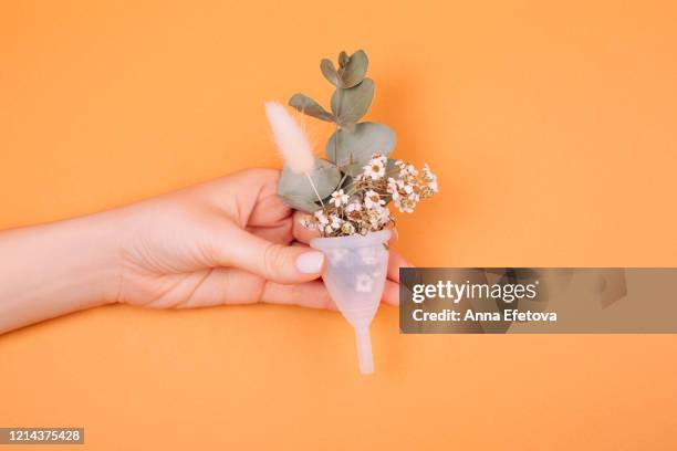 white menstrual cup with herbal leaf - cervix fotografías e imágenes de stock