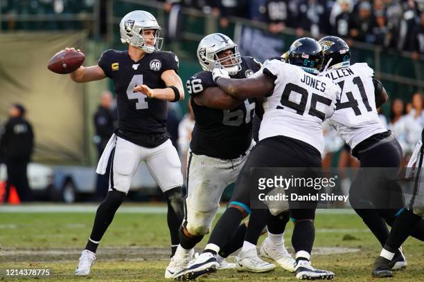 Derek Carr of the Oakland Raiders throws a pass during the second half against the Jacksonville Jaguars at RingCentral Coliseum on December 15, 2019...