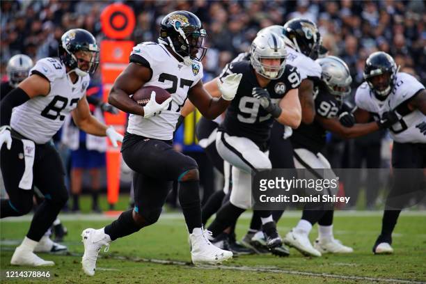 Leonard Fournette of the Jacksonville Jaguars runs the ball during the second half against the Oakland Raiders at RingCentral Coliseum on December...