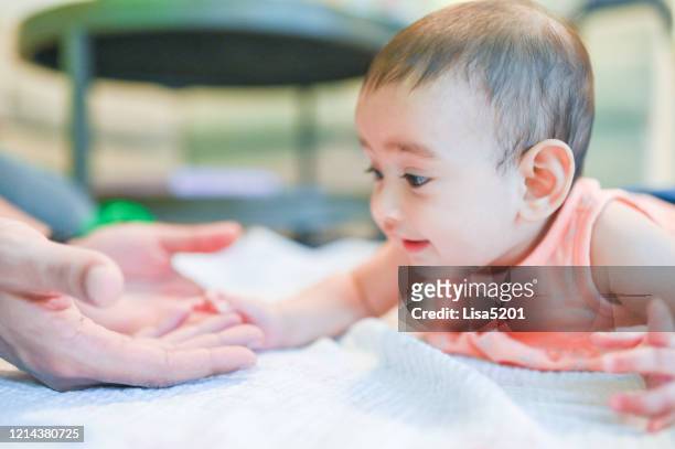 tummy time and infant baby girl - baby girl laying on tummy stock pictures, royalty-free photos & images