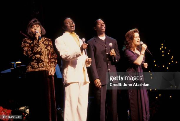 Singers Denise Williams, Philip Bailey, Jeffrey Osbourne and Sheena Easton are shown performing together during a holiday concert appearance on...