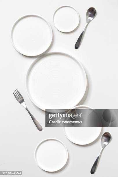 minimalist eating utensils still life. - plate with cutlery foto e immagini stock