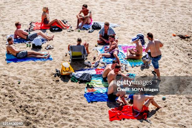 Beachgoers relax and enjoy the sun at Scheveningen beach on the Ascension Day. Warm weather drew crowds to the beach on the Ascension Day despite...