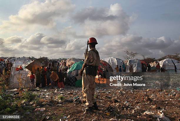 Somali soldier looks onto a camp for people displaced by famine and drought on August 19, 2011 in Mogadishu, Somalia. The UN says that more than...