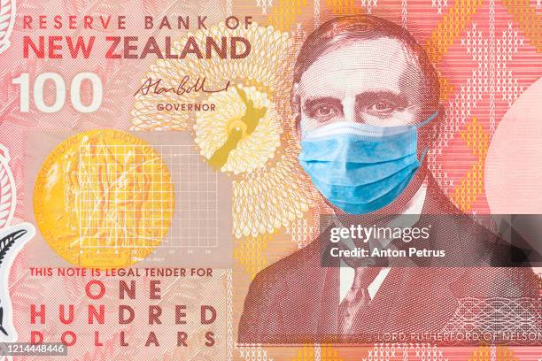 new zealand quarantine, 100 dollar banknote with medical mask. the concept of epidemic and protection against coronavrius. - new zealand money photos et images de collection