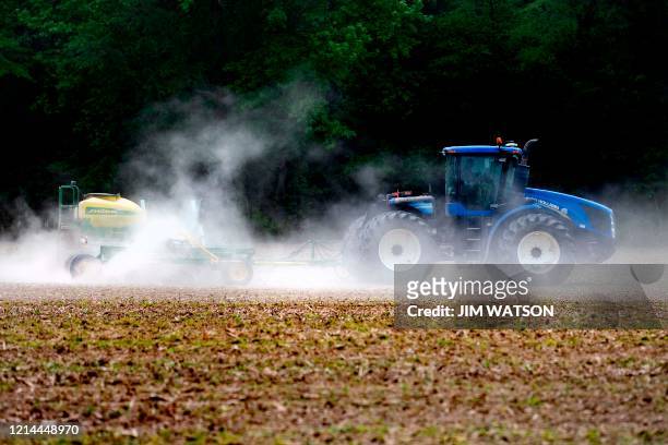 Farmer plows the field in Centreville, Maryland, on May 21, 2020 as struggling farmers and ranchers, many of whom have seen their markets collapse...