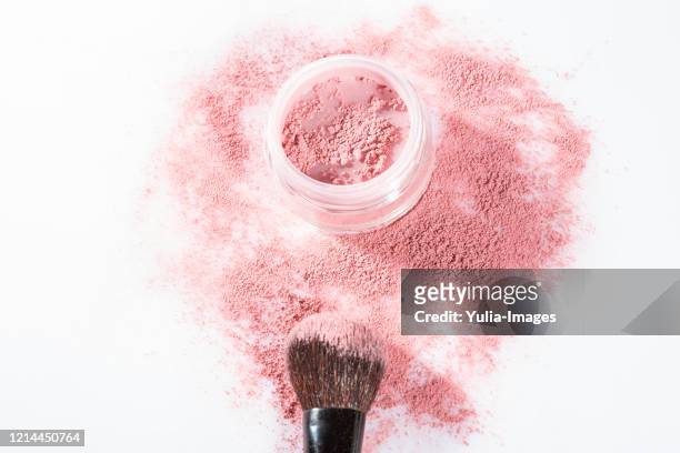 overhead close up of one open jar of spilled pink blush powder - puder stock-fotos und bilder