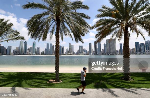 Man jogs past a empty beach on March 24, 2020 in Dubai, United Arab Emirates.On March 11 the World Health Organization declared coronavirus a global...