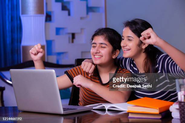 sister doing homework at home stock photo - girls stock pictures, royalty-free photos & images