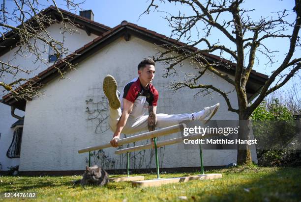 German gymnast Marcel Nguyen continues training for the Tokyo 2020 Olympics at his mother's garden on March 24, 2020 in Unterhaching, Germany. The...