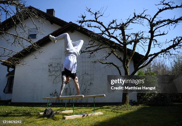 German gymnast Marcel Nguyen continues training for the Tokyo 2020 Olympics at his mother's garden on March 24, 2020 in Unterhaching, Germany. The...