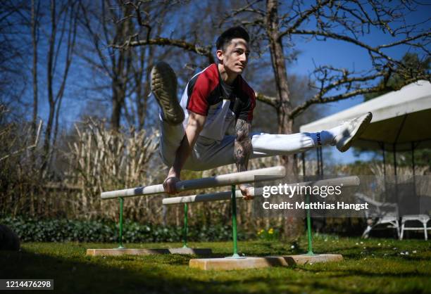 German gymnast Marcel Nguyen continues training for the Tokyo 2020 Olympics at his mother's garden on March 24, 2020 in Unterhaching, Germany. The...