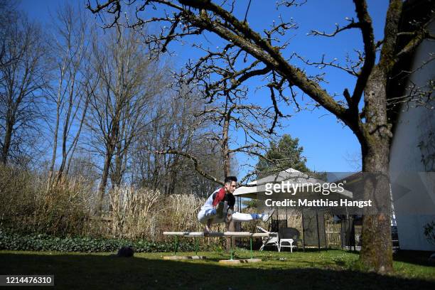 German gymnast Marcel Nguyen continues training for the Tokyo 2020 Olympics at his mother's garden on March 24, 2020 in Unterhaching, Germany. The...