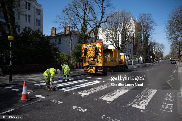 Highways Maintenance team takes advantage of the COVID-19 coronavirus lockdown and quiet streets to re-paint the iconic Abbey Road crossing on March...