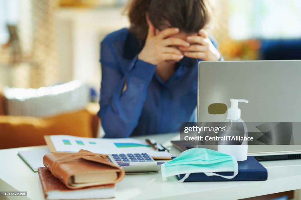 Medical mask and hand disinfectant and stressed woman