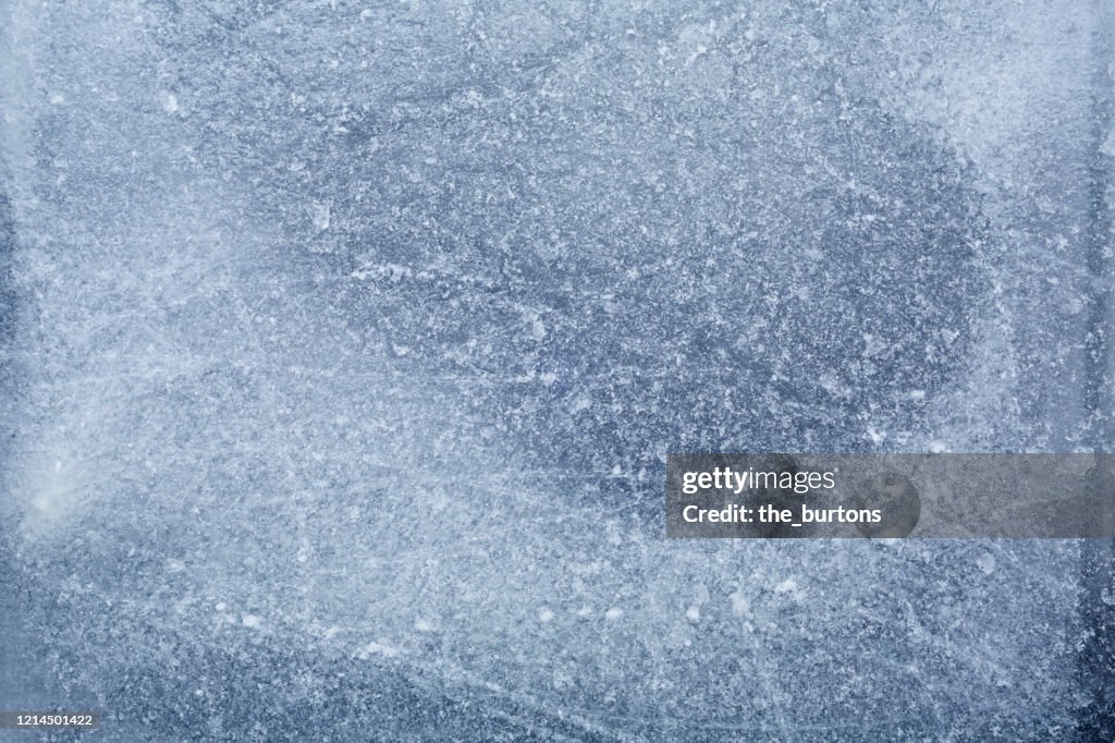 Full frame shot of scratched and frozen ice, abstract background