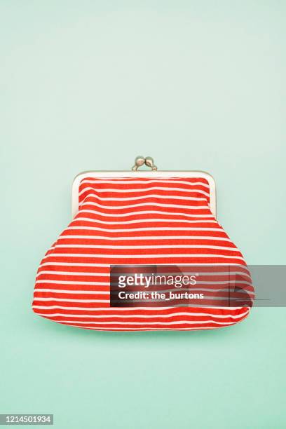 directly above shot of a red white striped wallet on turquoise background - blue purse stock pictures, royalty-free photos & images