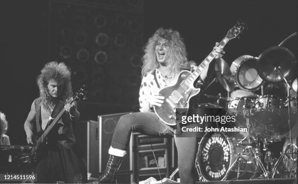 Musicians Tony Franklin and John Sykes are shown performing on stage during a live concert appearance with Blue Murder on November 30, 1989.