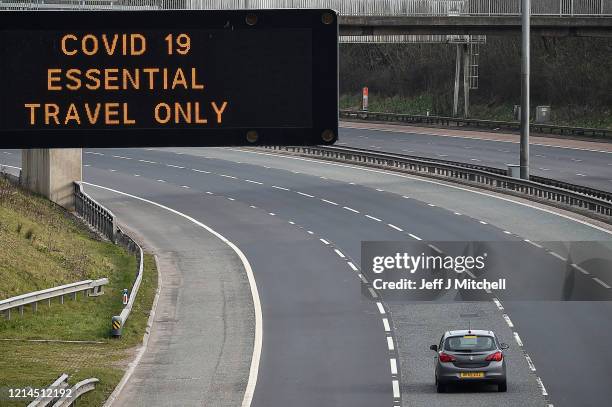 Motorway sign on the M8 motorway advising on essential travel only on March 24, 2020 in Glasgow, Scotland. First Minister of Scotland Nicola Sturgeon...