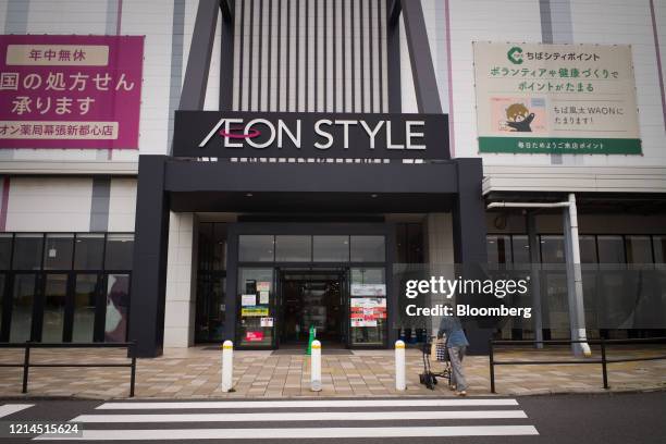 Shopper walks towards an Aeon Style store, operated by Aeon Retail Co., in Chiba, Japan, on Friday, May 22, 2020. Japans key inflation gauge slid...