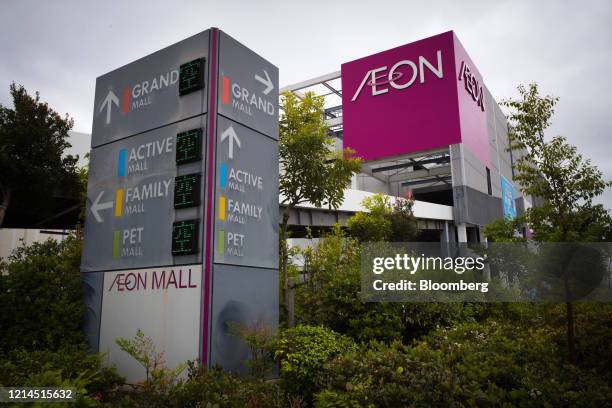 Signage is displayed atop an Aeon Co. Shopping mall in Chiba, Japan, on Friday, May 22, 2020. Japans key inflation gauge slid below zero in April for...