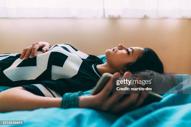 social distancing during covid-19 pandemic - girl in her bed stock pictures, royalty-free photos & images