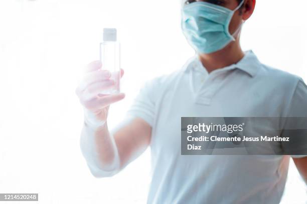 doctor washing hands covid virus with disinfectant gel - medico stock pictures, royalty-free photos & images