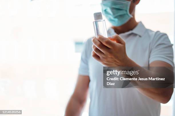 doctor washing hands covid virus with disinfectant gel - medico stock pictures, royalty-free photos & images