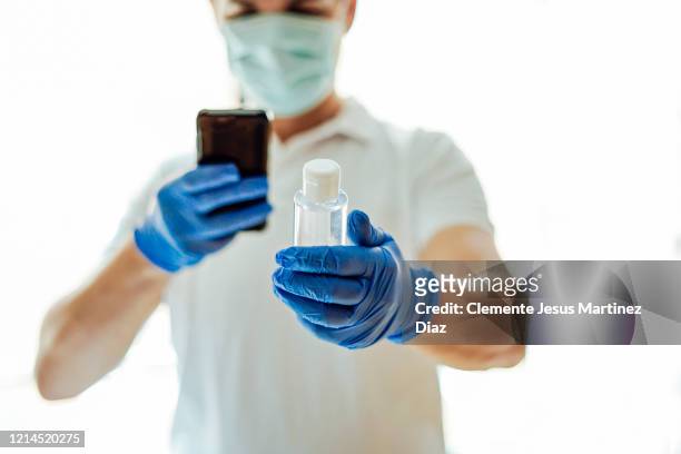 doctor washing hands covid virus with disinfectant gel - medico stock pictures, royalty-free photos & images
