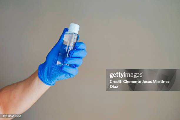 doctor washing hands covid virus with disinfectant gel - medico stock pictures, royalty-free photos & images