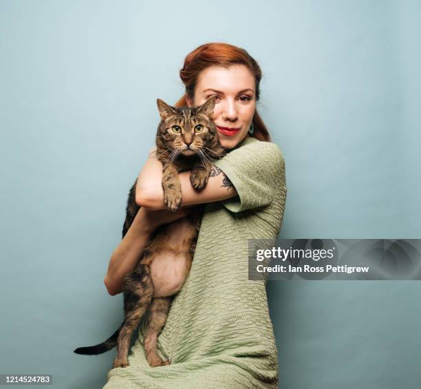 beautiful young woman holding cat - fond studio stock pictures, royalty-free photos & images