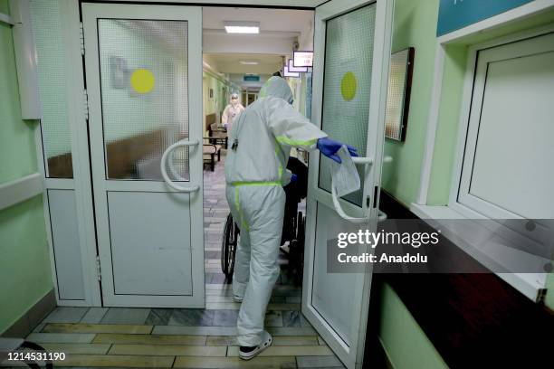 Healthcare workers wearing protective suit are seen on their duty a state hospital in Moscow, Russia on May 22, 2020. Russia remains second-worst-hit...