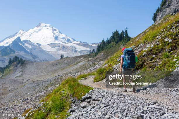 a woman on a backpacking trip in the mt baker wilderness. - mt baker stock pictures, royalty-free photos & images
