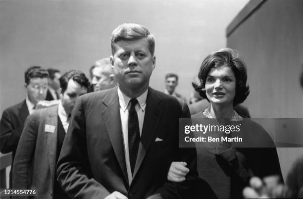 John F Kennedy and wife Jacqueline Kennedy arrive with advisors for split-screen telecast of the Presidential debate with Nixon and panelists in ABC...